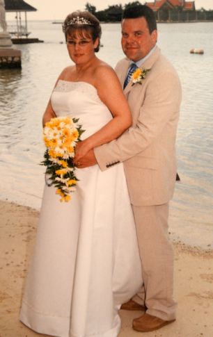 Devoted: The couple on their wedding day in Jamaica in 2003