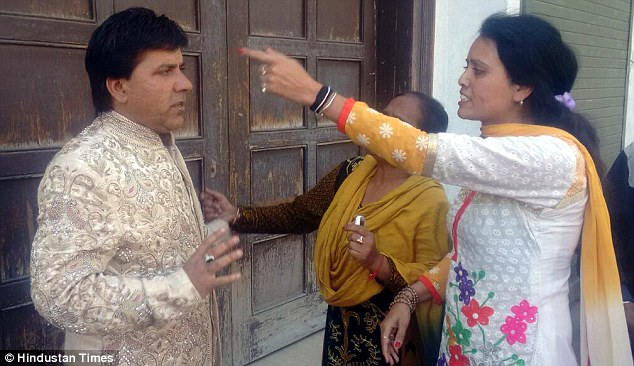 Sony looks confused as the woman claiming to be his first wife points angrily at him in India
