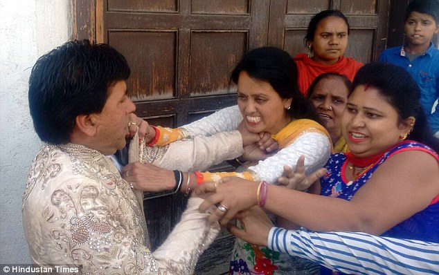 Vishal Kumar Sonu, 42, (left) is attacked by Rakhi (centre) and her family (right) at the wedding