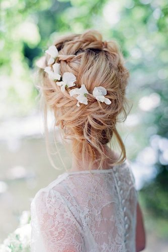 wedding hairstyles for medium hair messy updo with a braid texture and white flowers on blond hair hair and makeup by steph via instagram